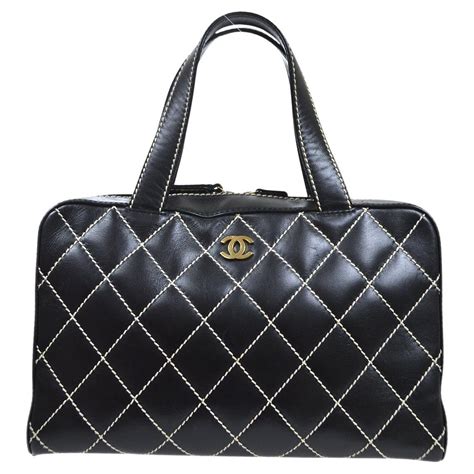 black leather chanel bag with yellow stiching